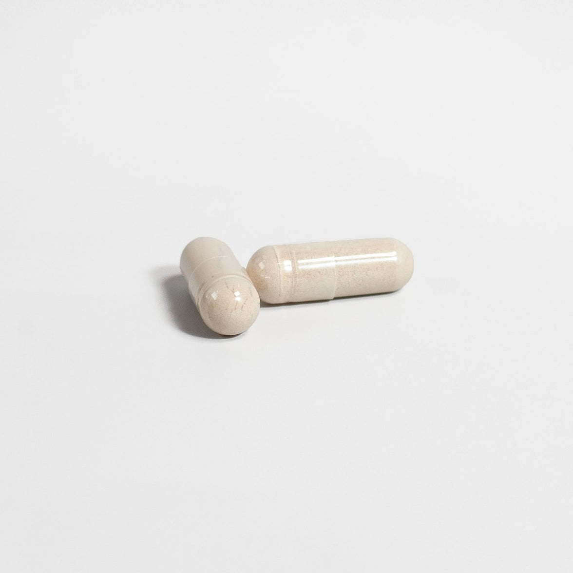 TeqenX Alpha Flow capsules in light beige, designed for men's vitality, supporting energy, muscle growth, and heart health.