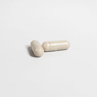 TeqenX Alpha Flow capsules in light beige, designed for men's vitality, supporting energy, muscle growth, and heart health.