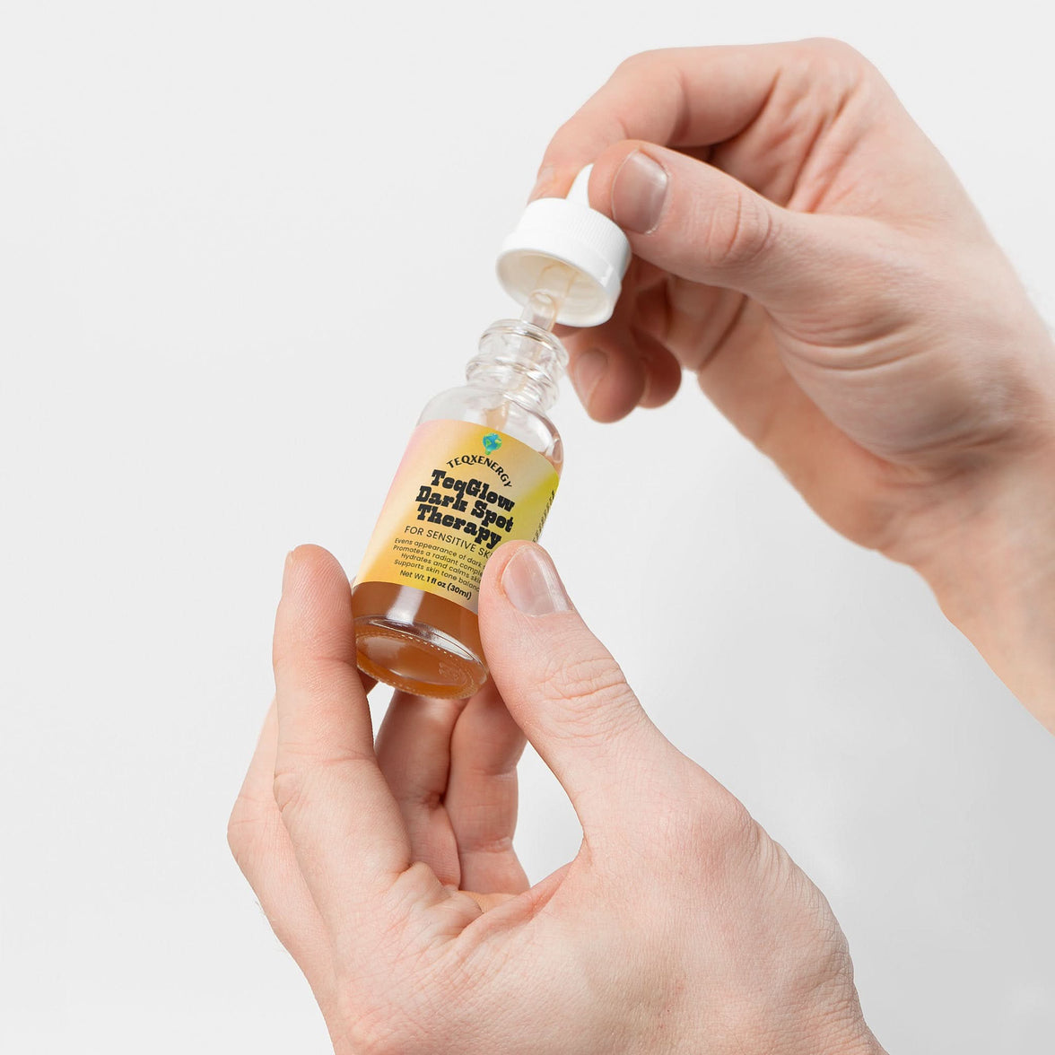 TeqGlow Dark Spot Therapy for sensitive skin features a dropper bottle, designed to hydrate and reduce dark spots gently. Formulated with adaptogenic mushrooms, chamomile, and calendula, this serum ensures effective results without harsh acids. Perfect for daily use, it balances moisture while promoting a clearer complexion. Transform your skin tone with TeqenX TeqGlow.