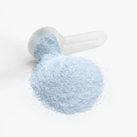 TeqenX ChargeUp Cotton Candy energy powder in a clear scoop, featuring a light blue color, perfect for sustained energy without crashes.