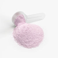 TeqenX ChargeUp Strawberry Shortcake energy powder in a clear scoop, featuring a fine pink texture for balanced energy without crashes.