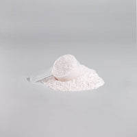 TeqenX ChargeUp+ Fruit Punch pre-workout powder with a scoop and spilled powder, designed for energy, muscle pumps, and focus.
