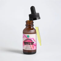 TeqenX Women's Hair Revival Oil in a brown glass dropper bottle, featuring a pink and white label, promotes hair growth and scalp health.