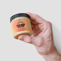 TeqenX Raw Shea Butter in a round container with a black lid, offering organic unrefined moisture for face, body, and hair.