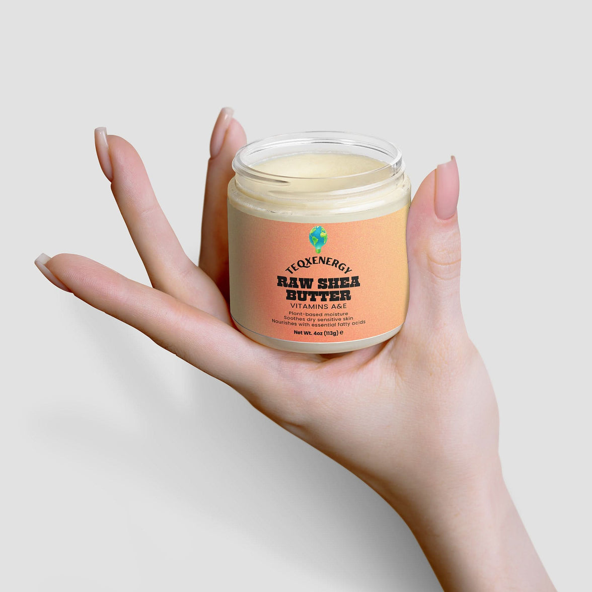 TeqenX Raw Shea Butter in a clear jar, creamy texture, light orange label highlighting vitamins A & E for deep hydration.