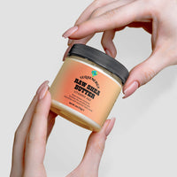 TeqenX Raw Shea Butter jar held in hands, featuring a black lid and label highlighting Vitamins A & E for natural skincare.