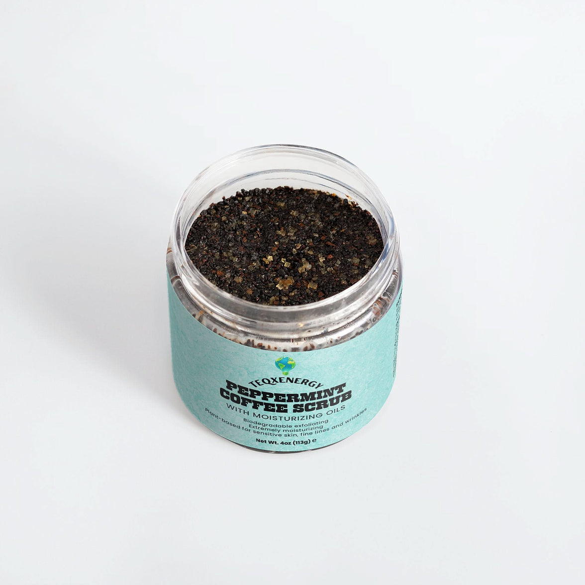 TeqenX Peppermint Coffee Scrub in a clear jar with a light blue label, showcasing its dark, textured exfoliating formula.