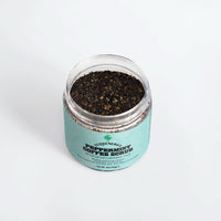 TeqenX Peppermint Coffee Scrub in a clear jar with a light blue label, showcasing its dark, textured exfoliating formula.