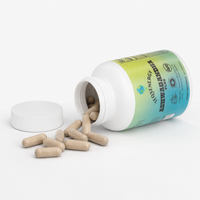 White bottle of Ashwagandha Plus with a green and blue label, showcasing beige capsules spilling out.